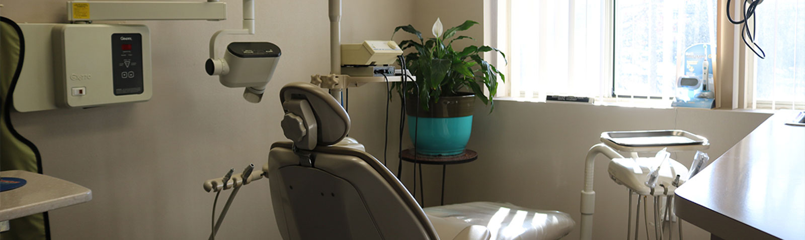 An interior view of a dental office, featuring dental chairs and equipment.