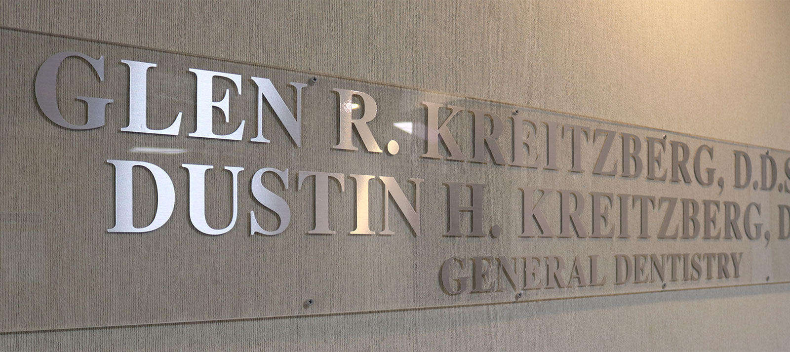 The image shows a sign with the name  Glen R. Kretzberg  prominently displayed, indicating that this is likely an establishment or organization related to dental care, as suggested by the text below the name that reads  General Dental.
