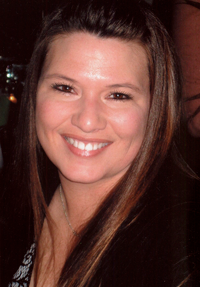 Woman with long hair, smiling at the camera.