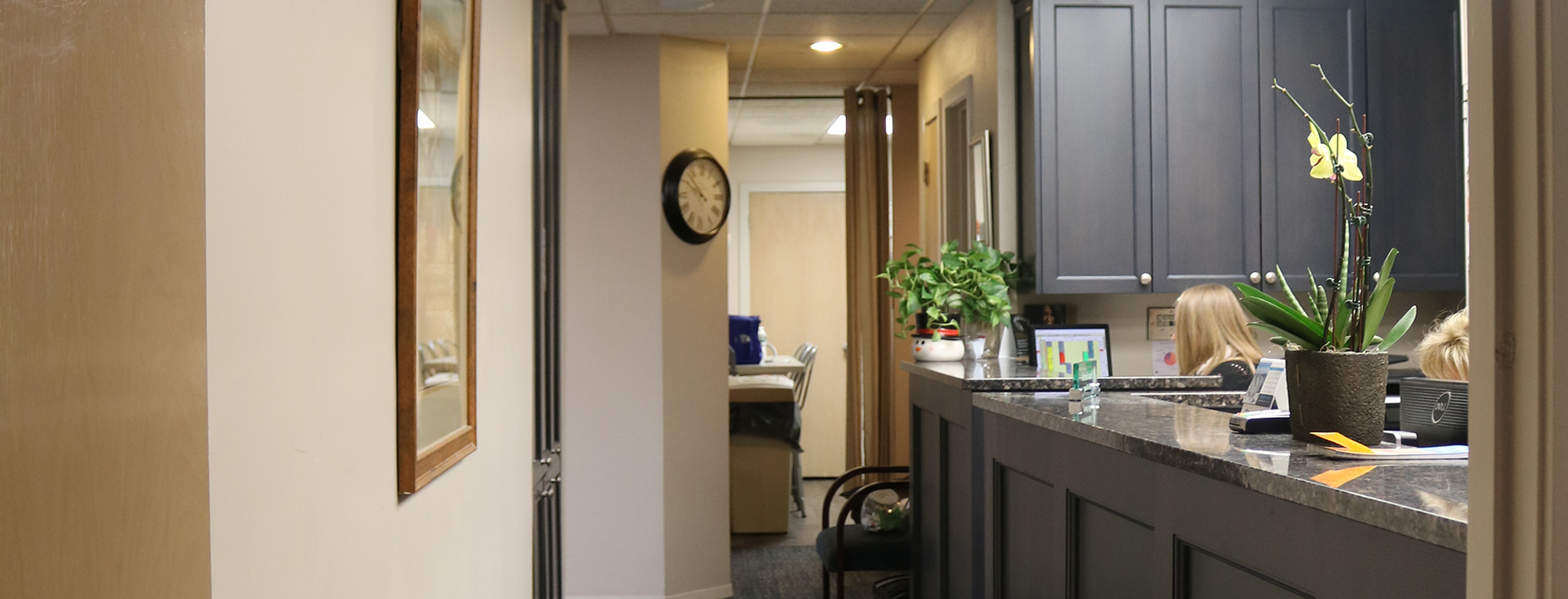 The image shows a modern bathroom interior with a focus on the vanity area, featuring a sink and mirror.