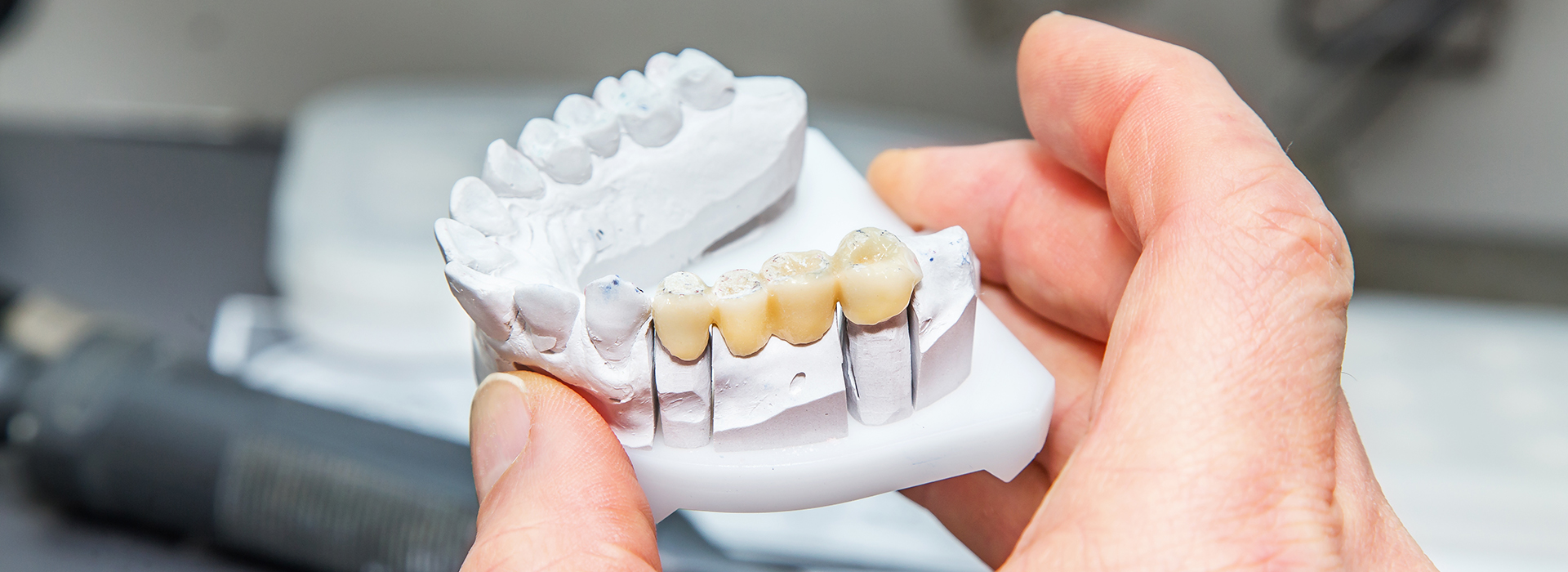 An image of a person holding a toothbrush with a toothpaste-covered bristle, showing the brush s effectiveness in cleaning teeth.